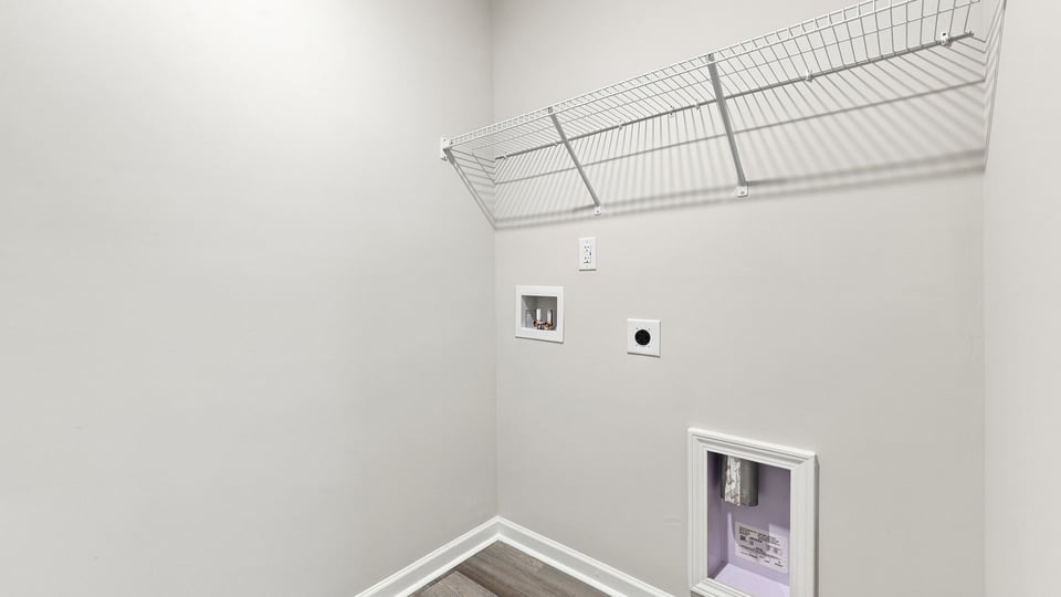 Laundry room with shelf.