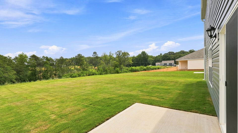 Back exterior with large backyard.