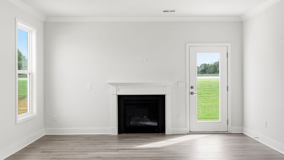 Living room with fireplace and window.