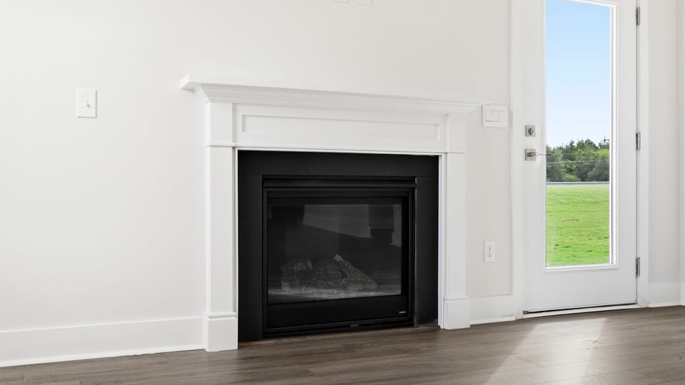 Living room with fireplace and window.