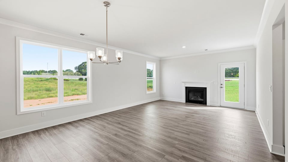 Living room with fireplace and window.
