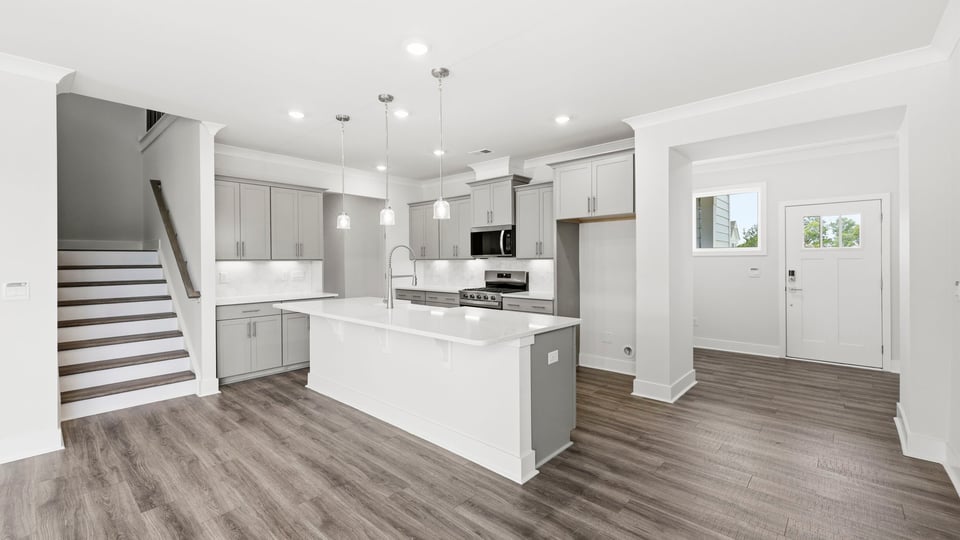 Kitchen and quartz countertops and stainless steel appliances.