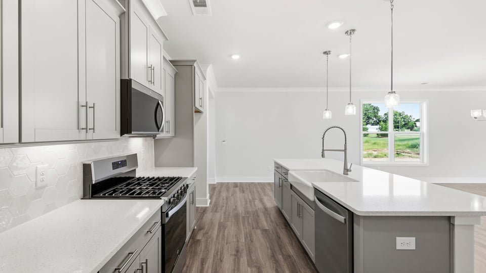Kitchen and quartz countertops and stainless steel appliances.
