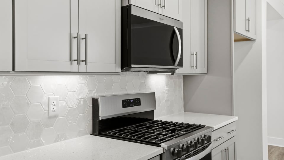 Kitchen and quartz countertops and stainless steel appliances.
