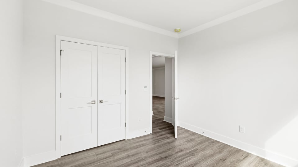 Bedroom with carpet and window.