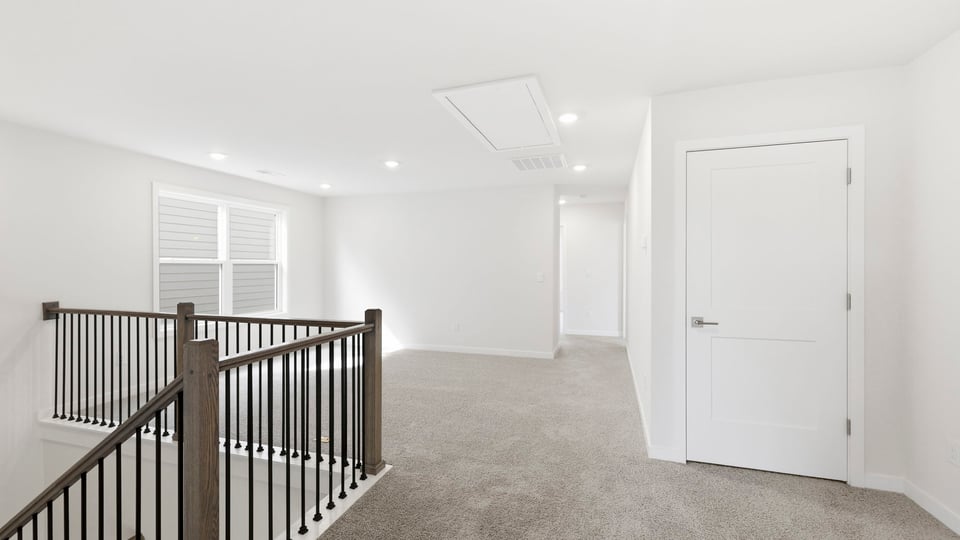 Loft with carpet and windows.
