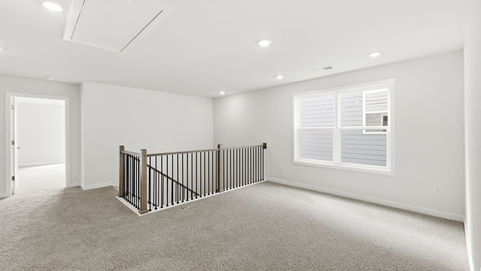 Loft with carpet and windows.