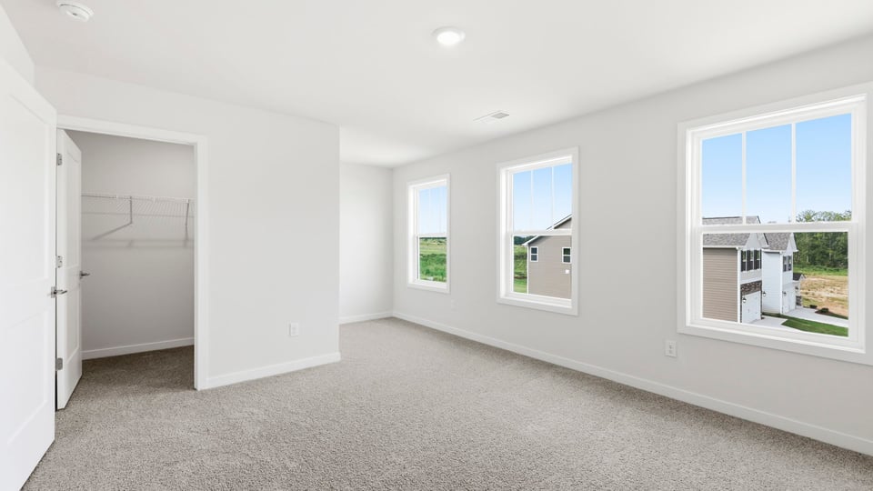 Bedroom with carpet and window.