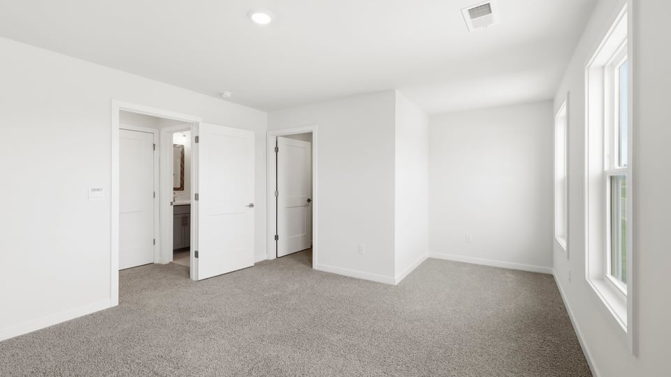 Bedroom with carpet and window.