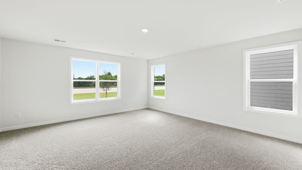 Bedroom with carpet and window.