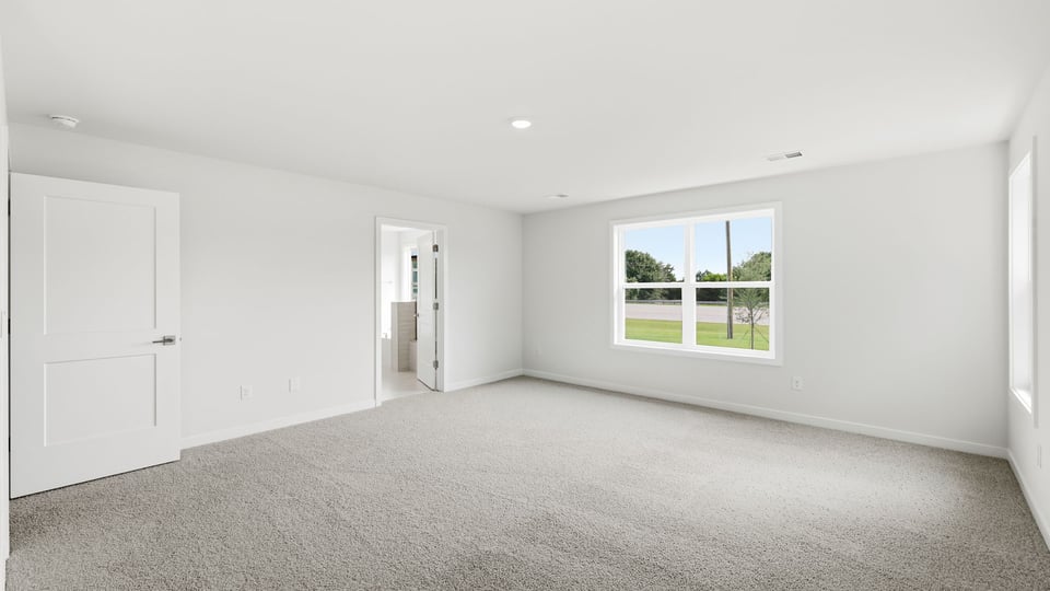 Bedroom with carpet and window.