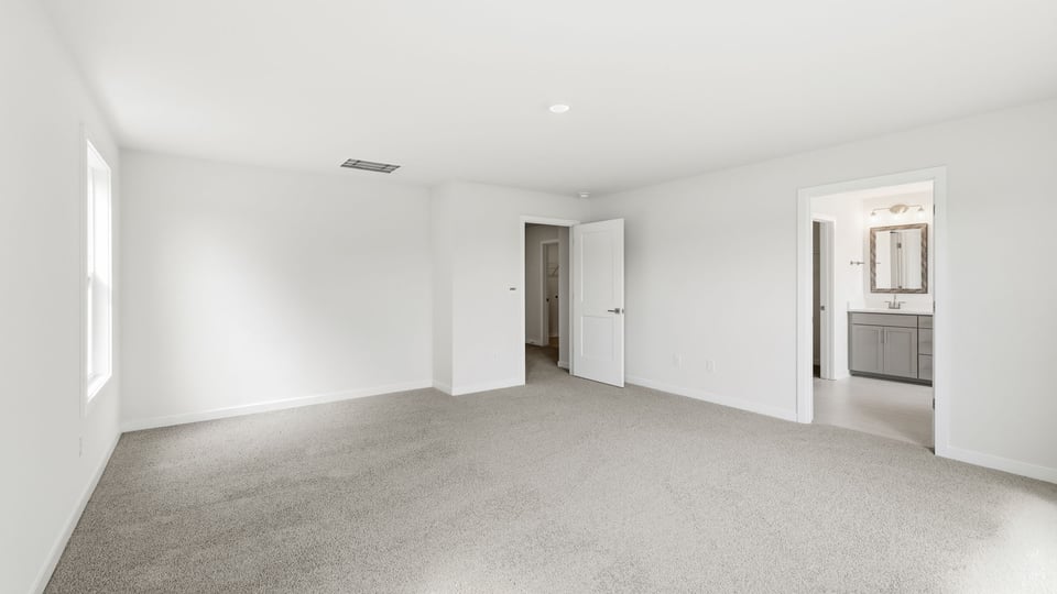 Bedroom with carpet and window.