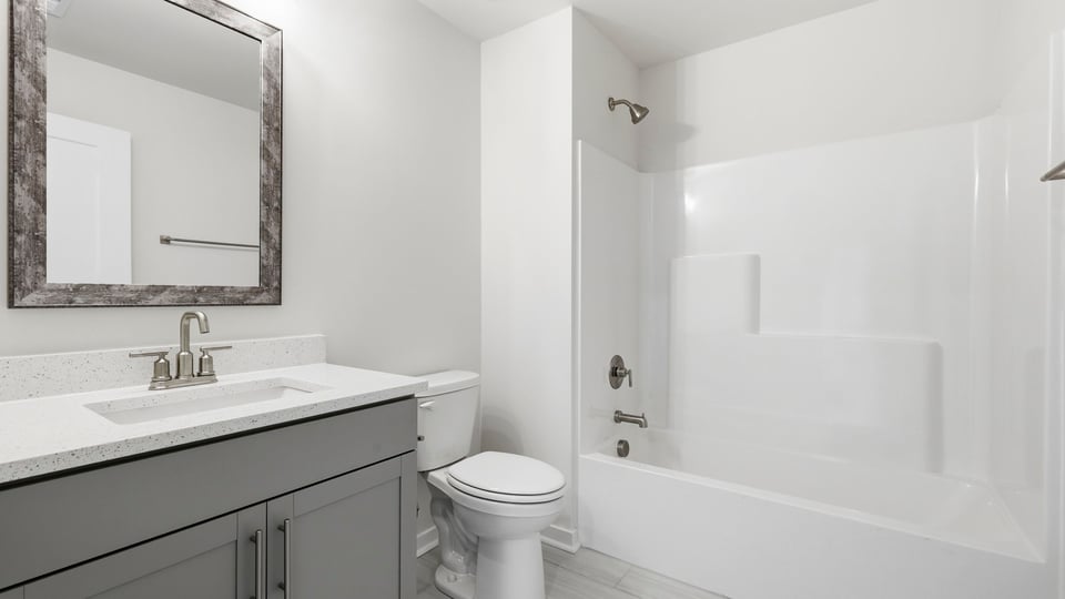Bathroom with single vanity sink and bathtub.