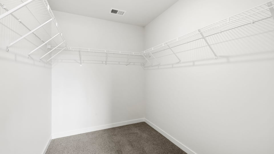 Closet with hanging storage racks.