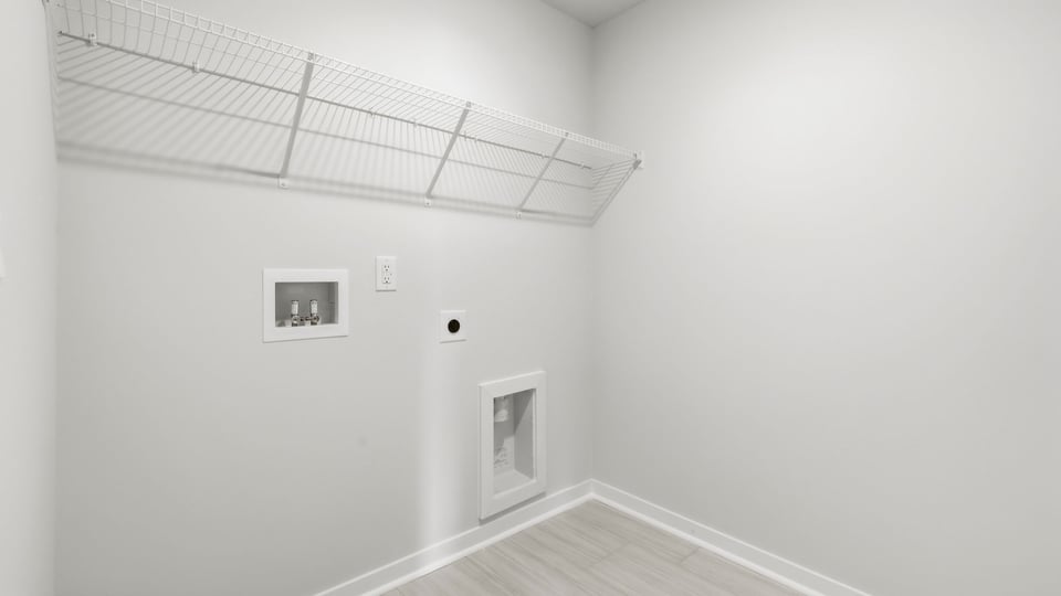 Laundry room with hanging storage racks.