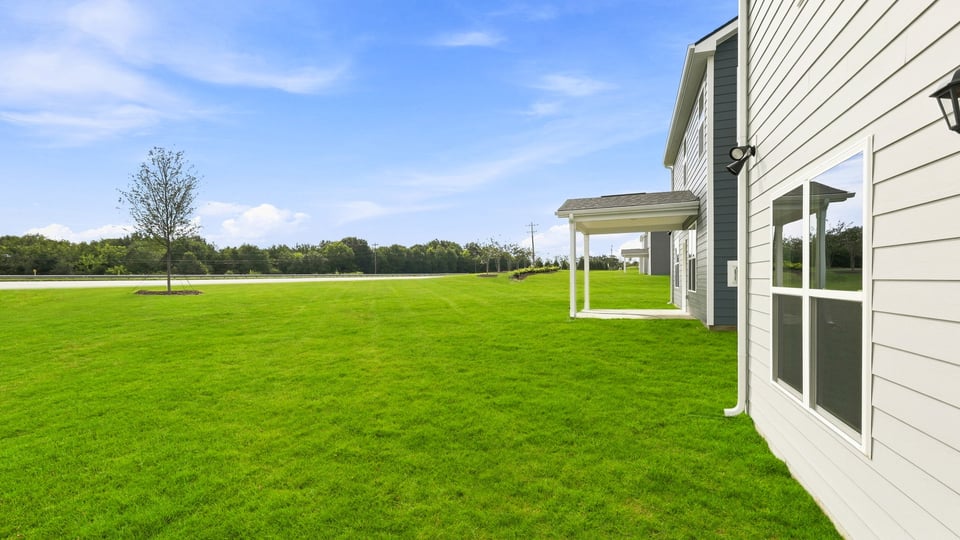 Back exterior of home large backyard.