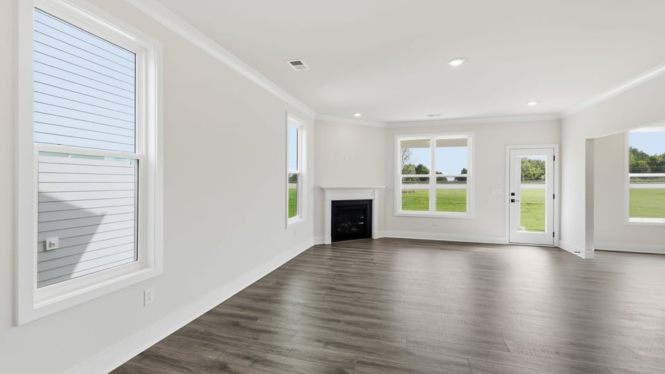 Living room with windows and fireplace.