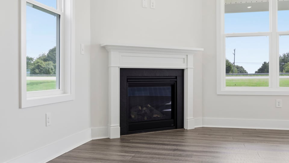 Living room with windows and fireplace.