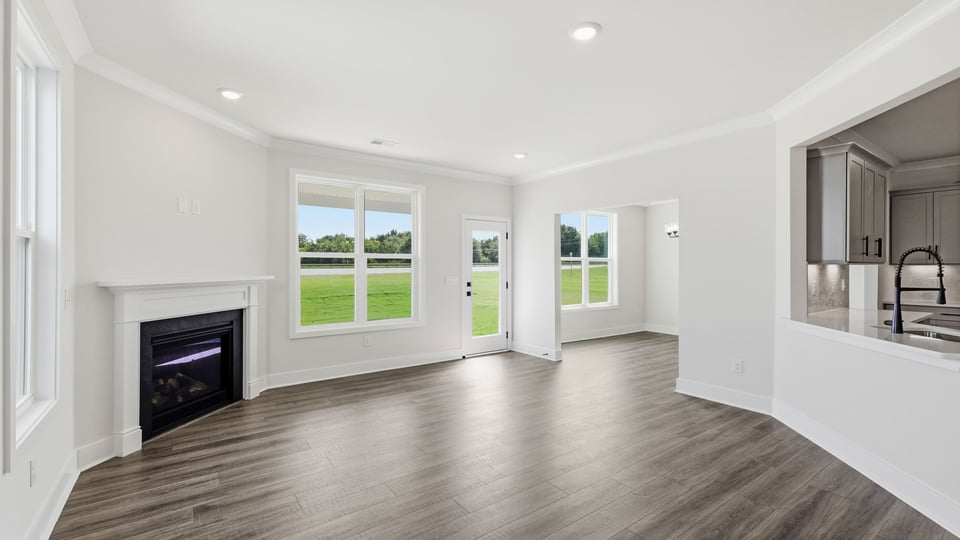 Living room with windows and fireplace.