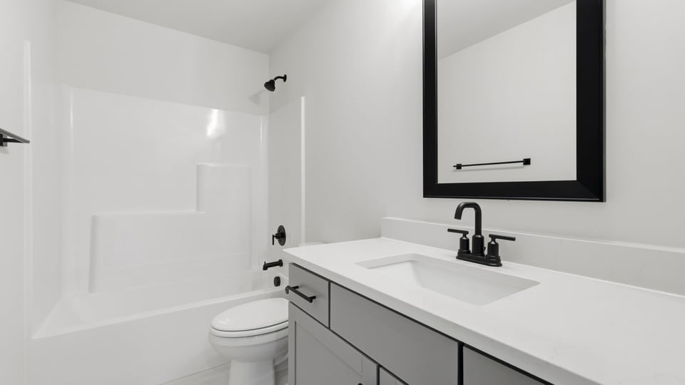 Bathroom with single vanity sink and bathtub.