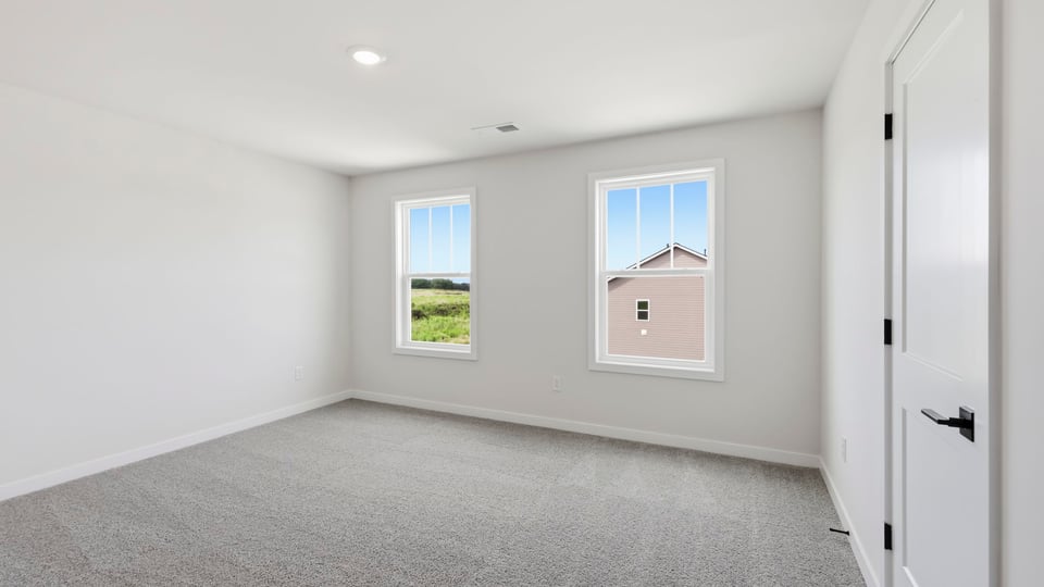 Bedroom with carpet and window.
