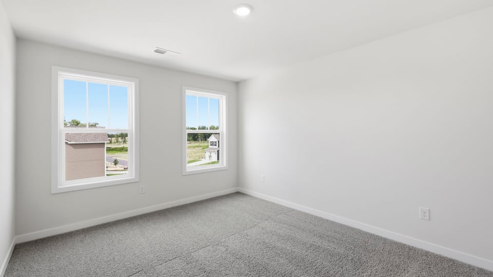 Bedroom with carpet and window.