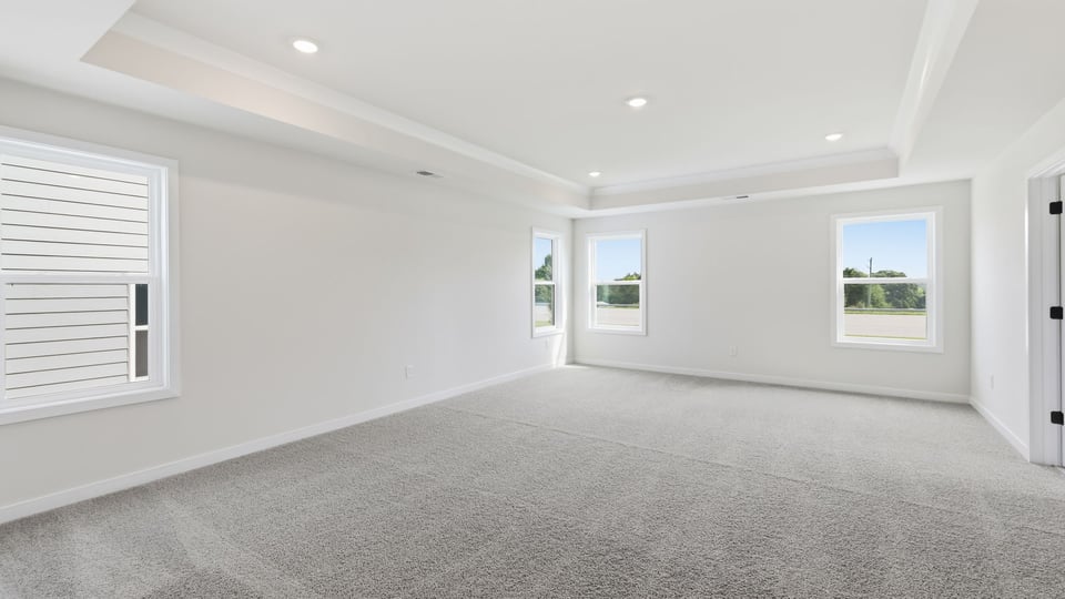 Bedroom with carpet and window.