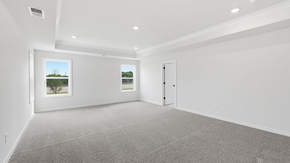 Bedroom with carpet and window.