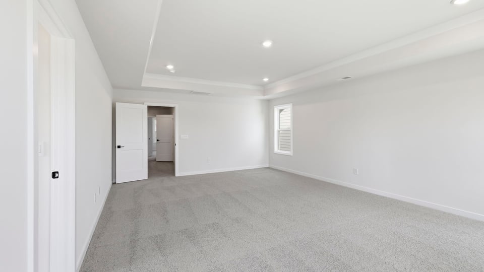 Bedroom with carpet and window.