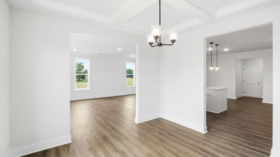 Kitchen and island with quartz countertops and stainless steel appliances.
