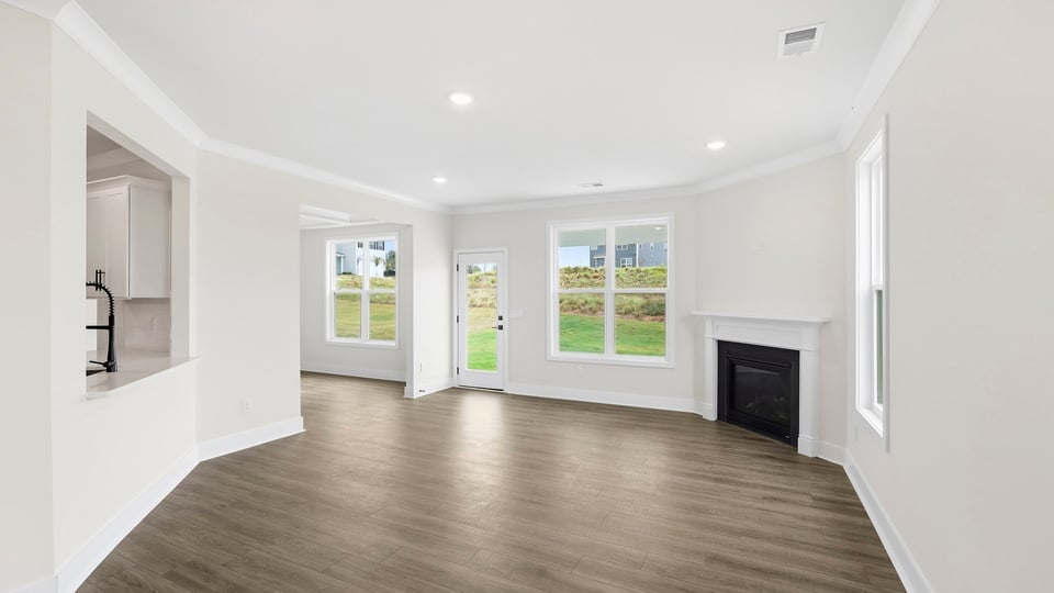 Living room with windows and fireplace.