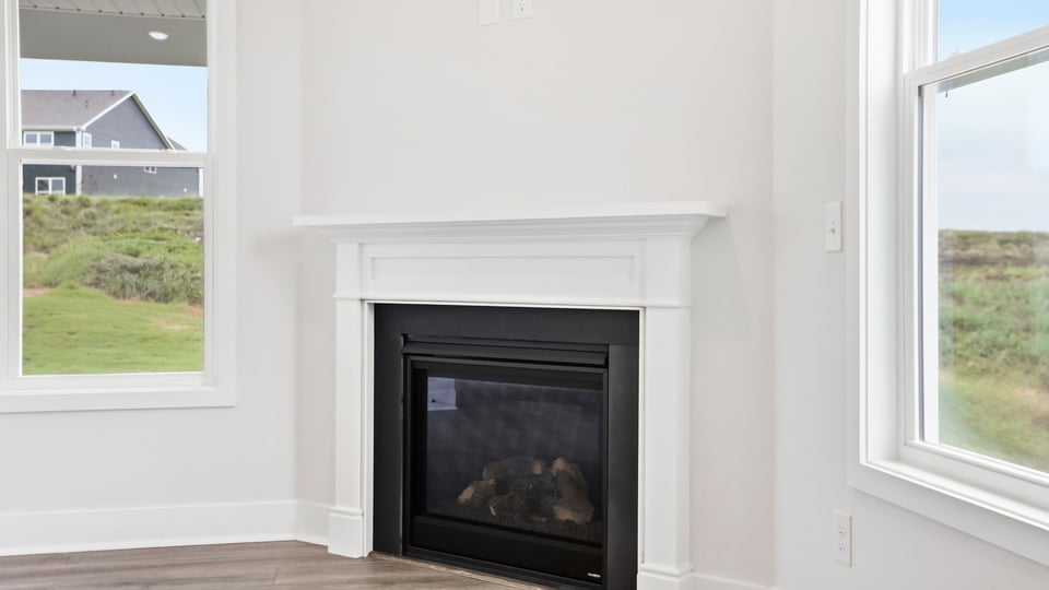 Living room with windows and fireplace.