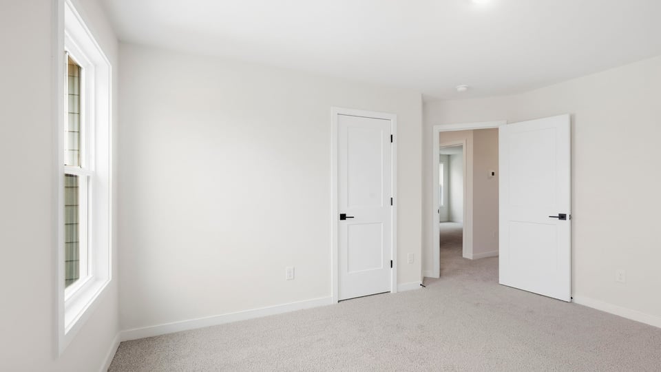 Bedroom with carpet and window.