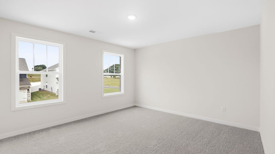 Bedroom with carpet and window.