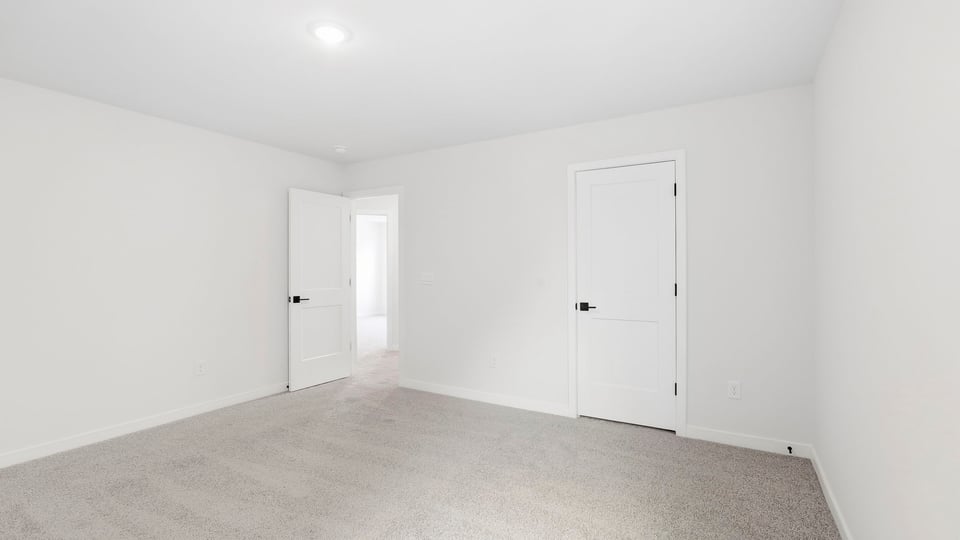 Bedroom with carpet and window.