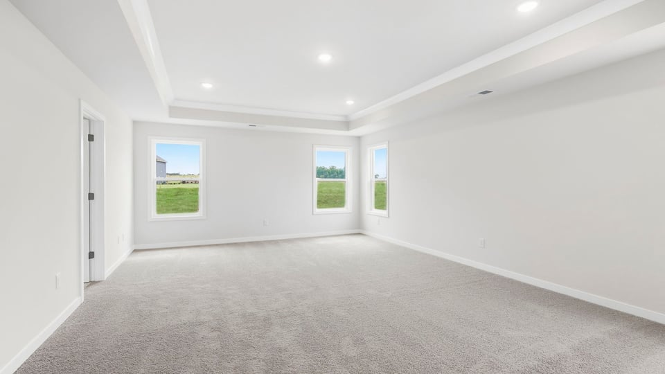 Bedroom with carpet and window.
