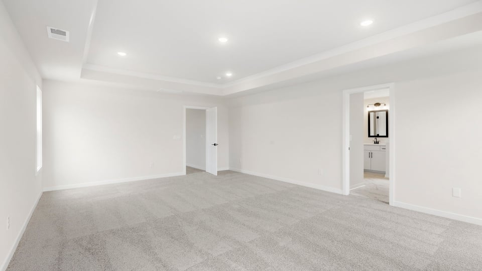 Bedroom with carpet and window.
