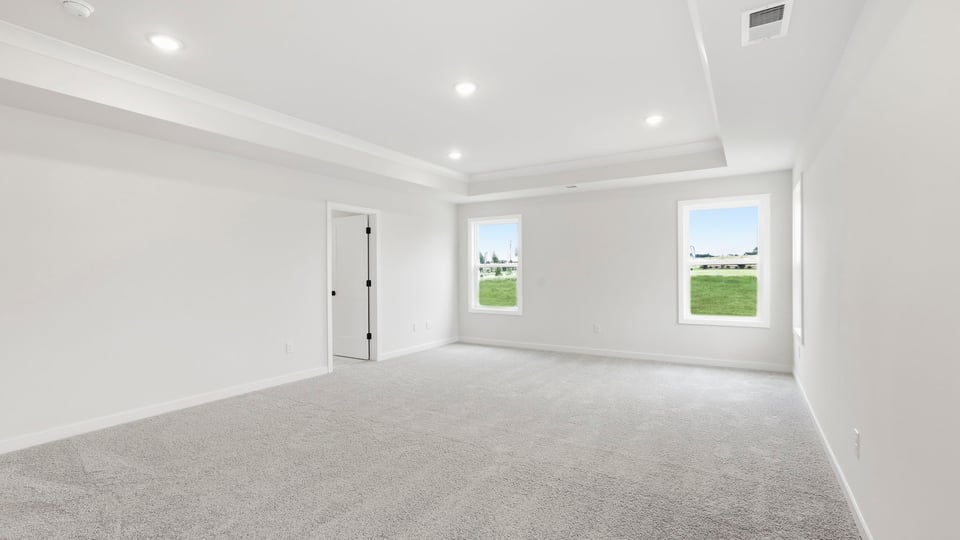 Bedroom with carpet and window.