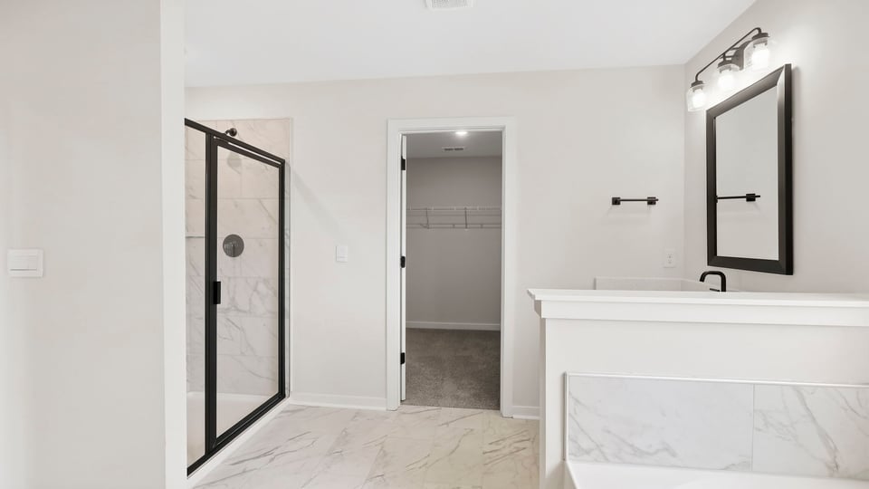 Bathroom with walk in shower and closet.