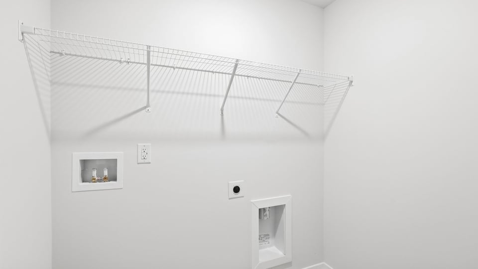 Laundry room with hanging storage racks.