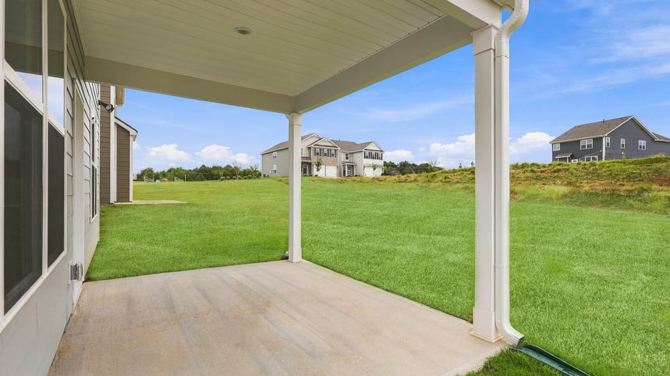 Back exterior of home with covered patio.