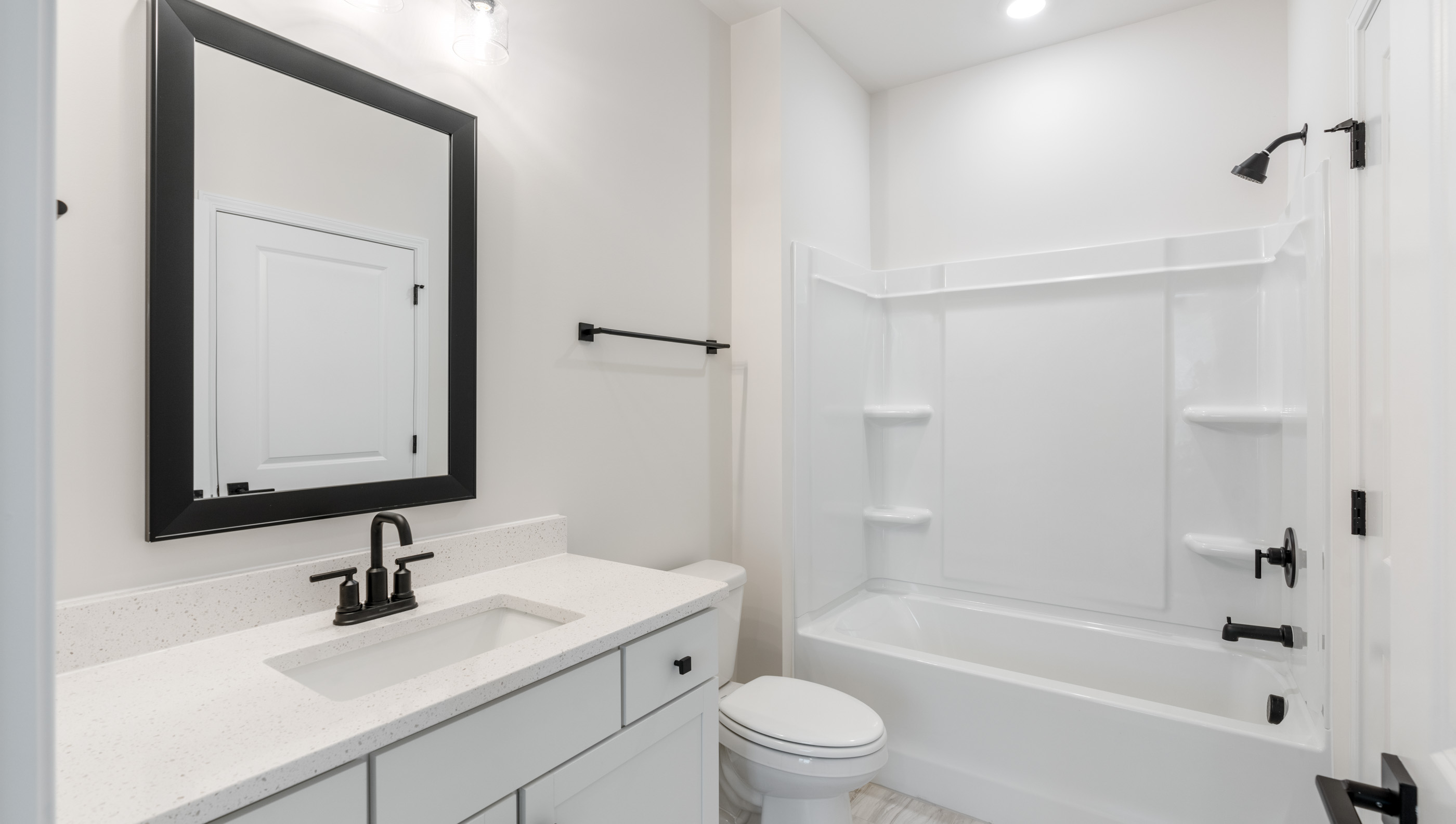 Bathroom with vanity and walk in tub.