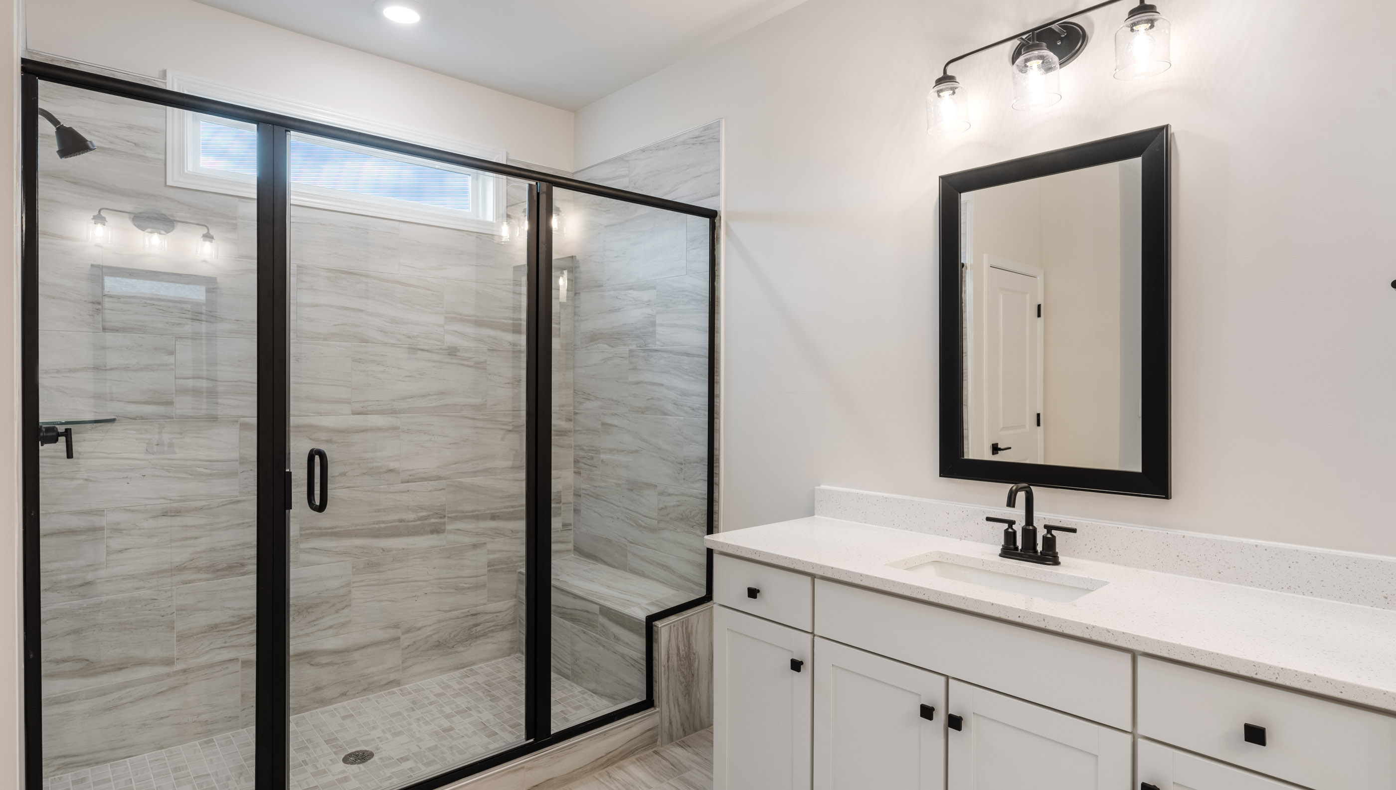 Bathroom with vanity and walk in shower.