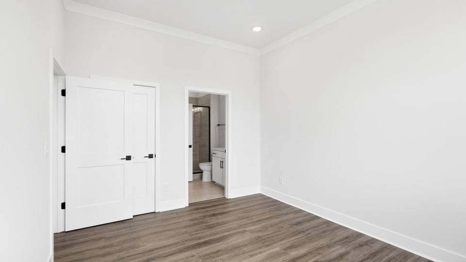 Bedroom with carpet and window.