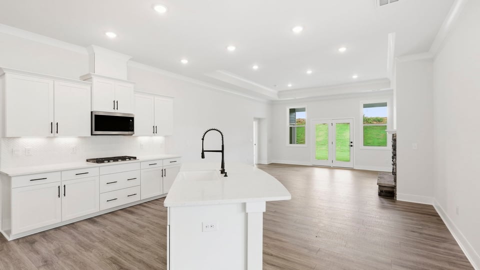 Kitchen and island with quartz countertops.