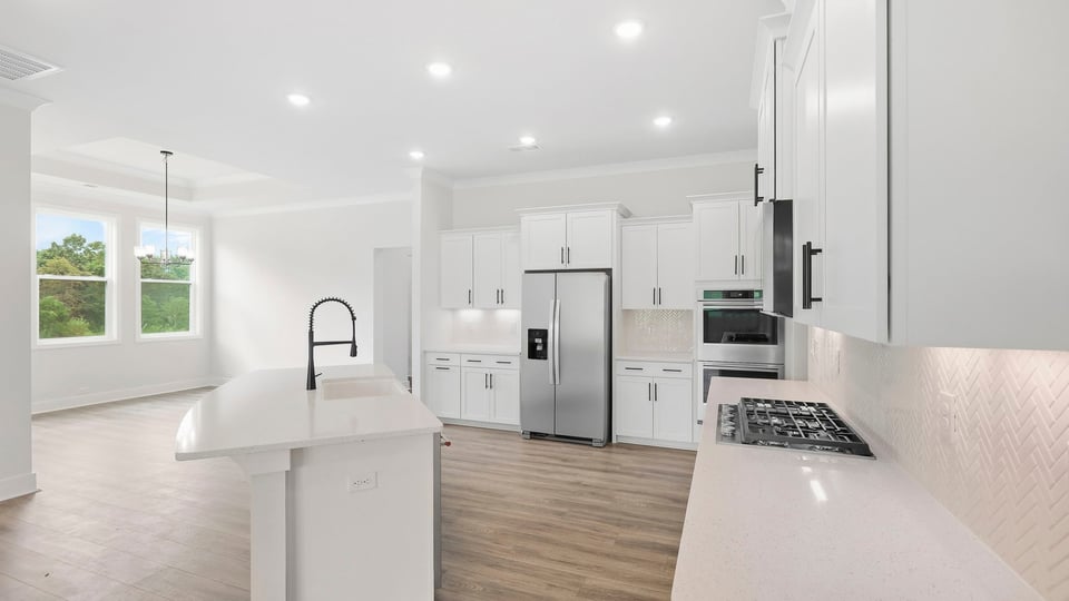 Kitchen and island with quartz countertops.