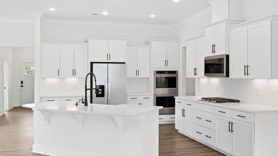 Kitchen and island with quartz countertops.