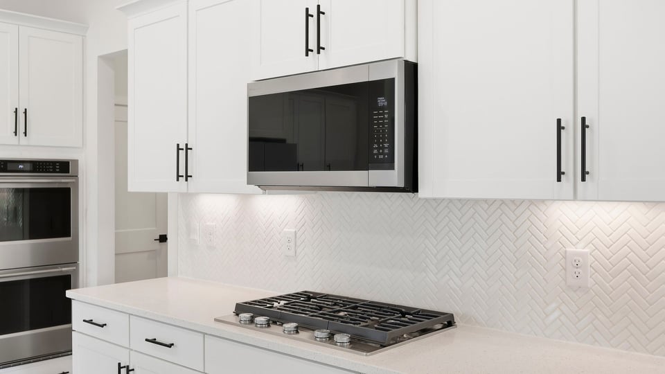 Kitchen and island with quartz countertops.