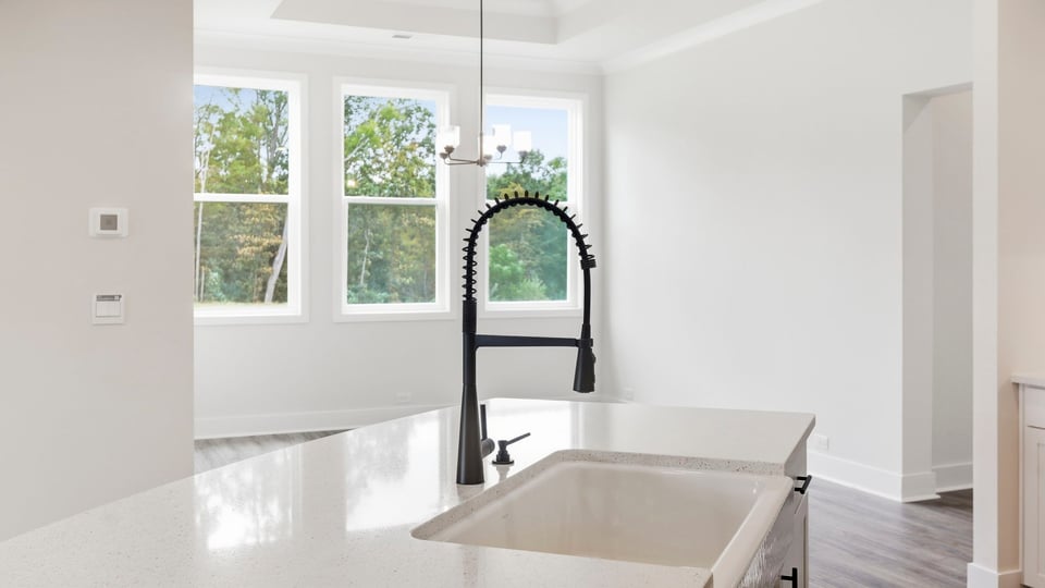 Kitchen and island with quartz countertops.