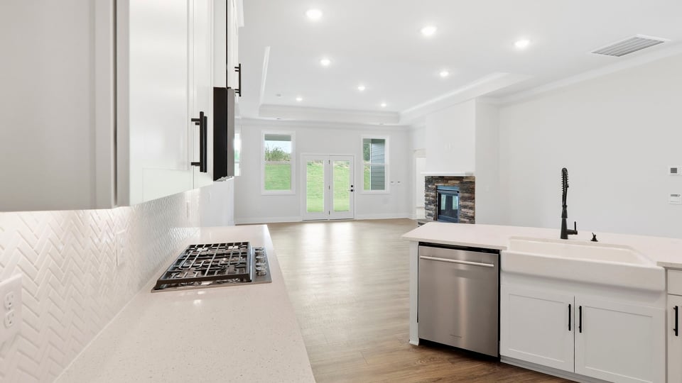 Kitchen and island with quartz countertops.